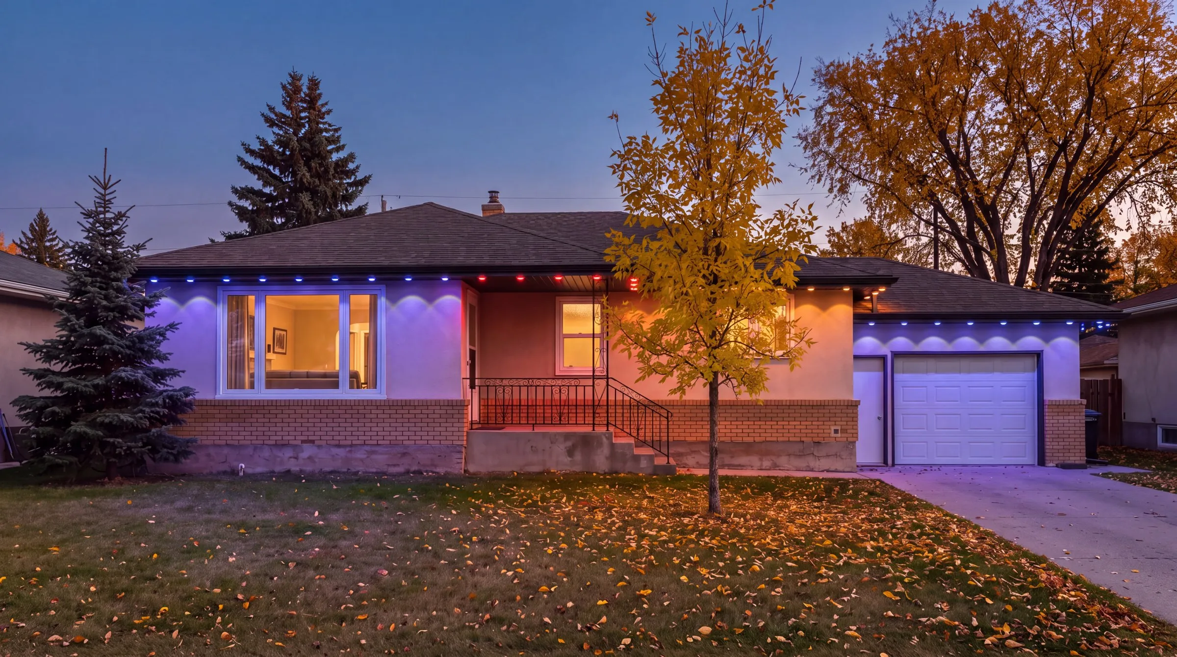 Winnipeg bungalow in October with Govee permanent lights in purple, red and orange blocks along the eaves, golden elms behind