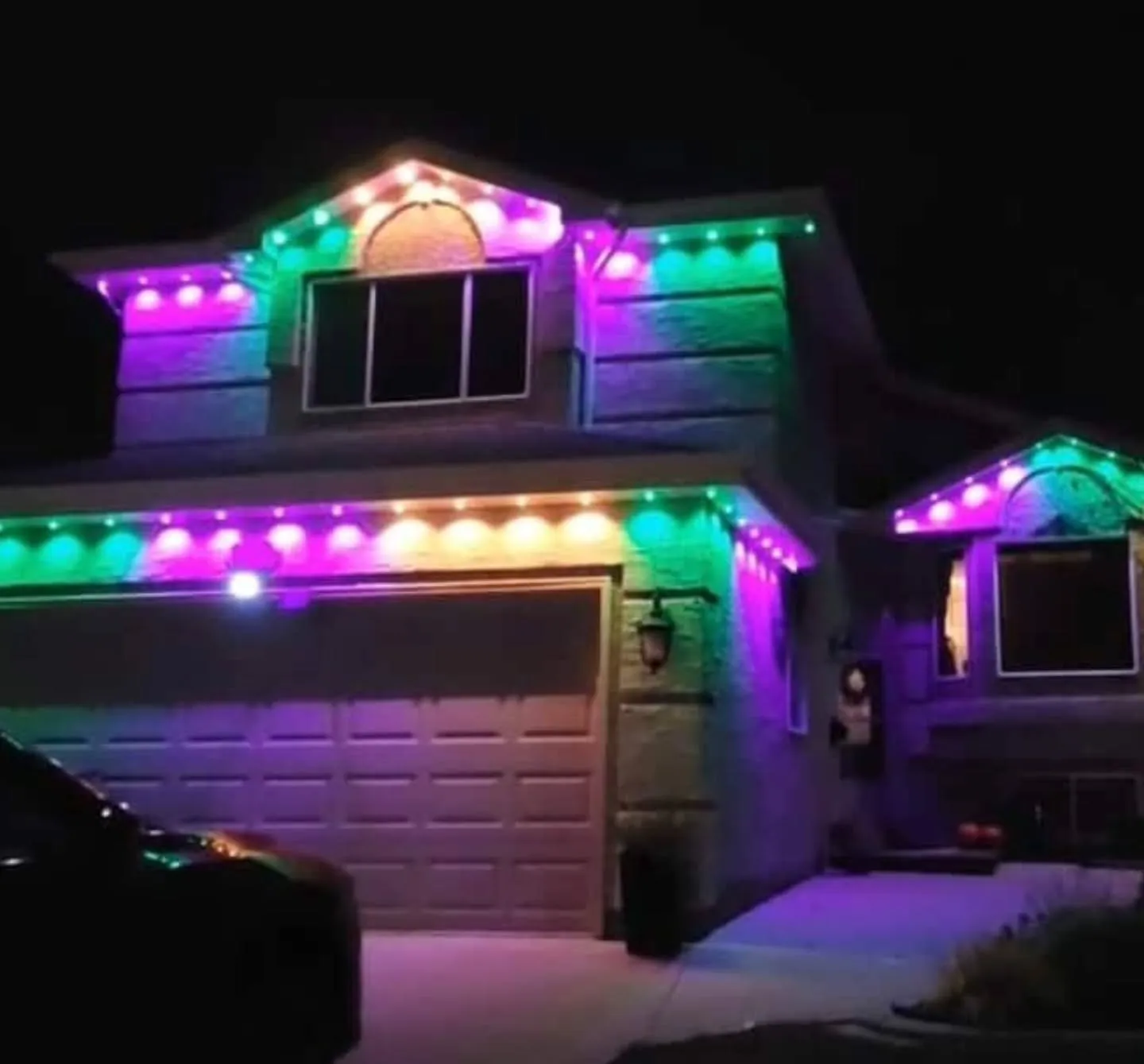 Winnipeg two-storey home with Govee permanent lights in a full rainbow pattern along every roofline