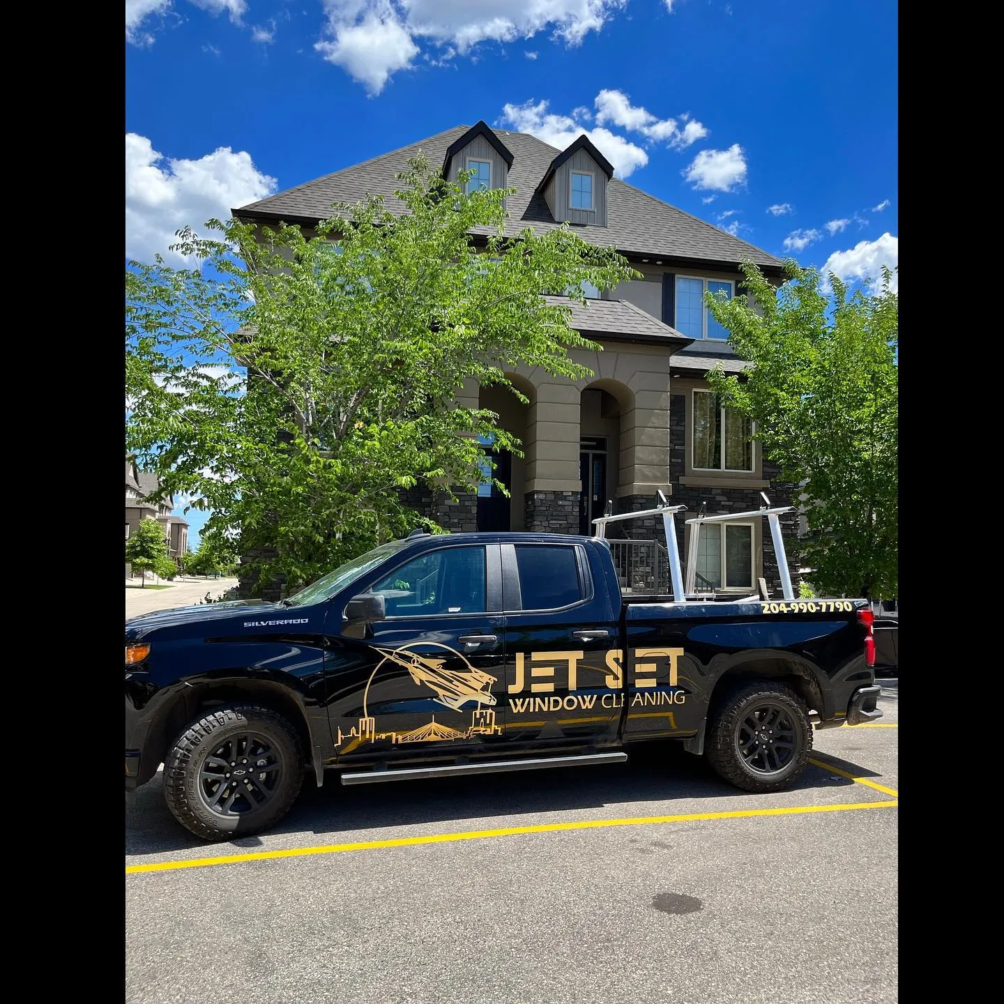Jet Set truck in front of a large Winnipeg home